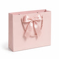 Borsa regalo 32 x 12 x 26 cm in carta rosa con manici in corda e fiocco decorativo